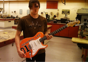 Student shows off finished guitar