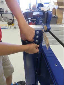 Middle schooler helps assemble a ShopBot