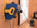 Carving on a vertical wall: a vacuum pump is holding the Handibot to the wall.